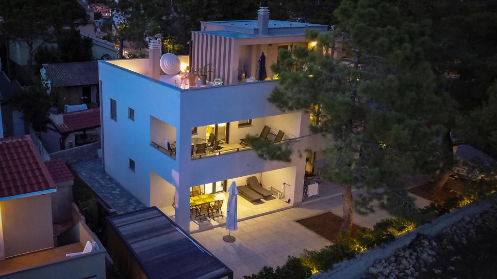an aerial view of a white house at night at CUBE apartments in Vir
