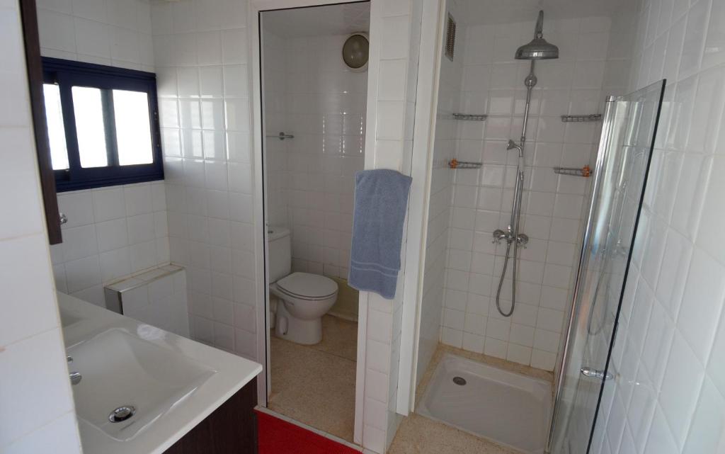 a bathroom with a shower and a toilet and a sink at logis la marine in Sidi Ifni