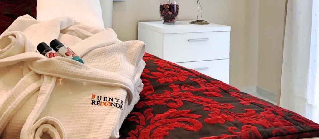 Łóżko lub łóżka w pokoju w obiekcie VENUS DE BAEZA SUITE