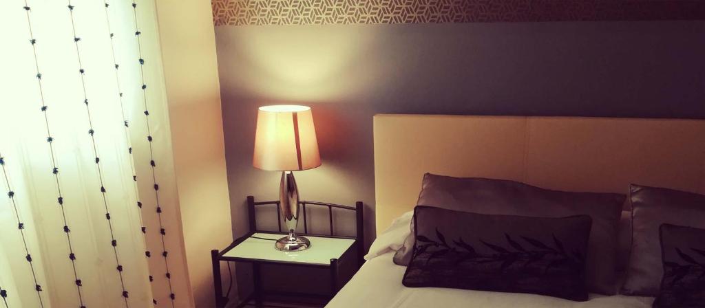 Łóżko lub łóżka w pokoju w obiekcie VENUS DE BAEZA SUITE