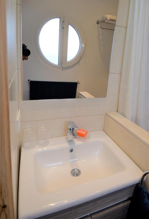 a bathroom with a sink and a mirror at logis la marine in Sidi Ifni