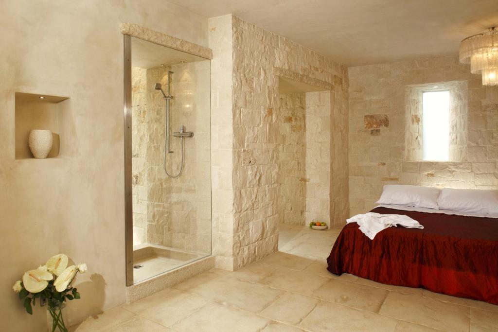 a bathroom with a shower and a bed and a tub at Via Paradiso 32 in Feltre