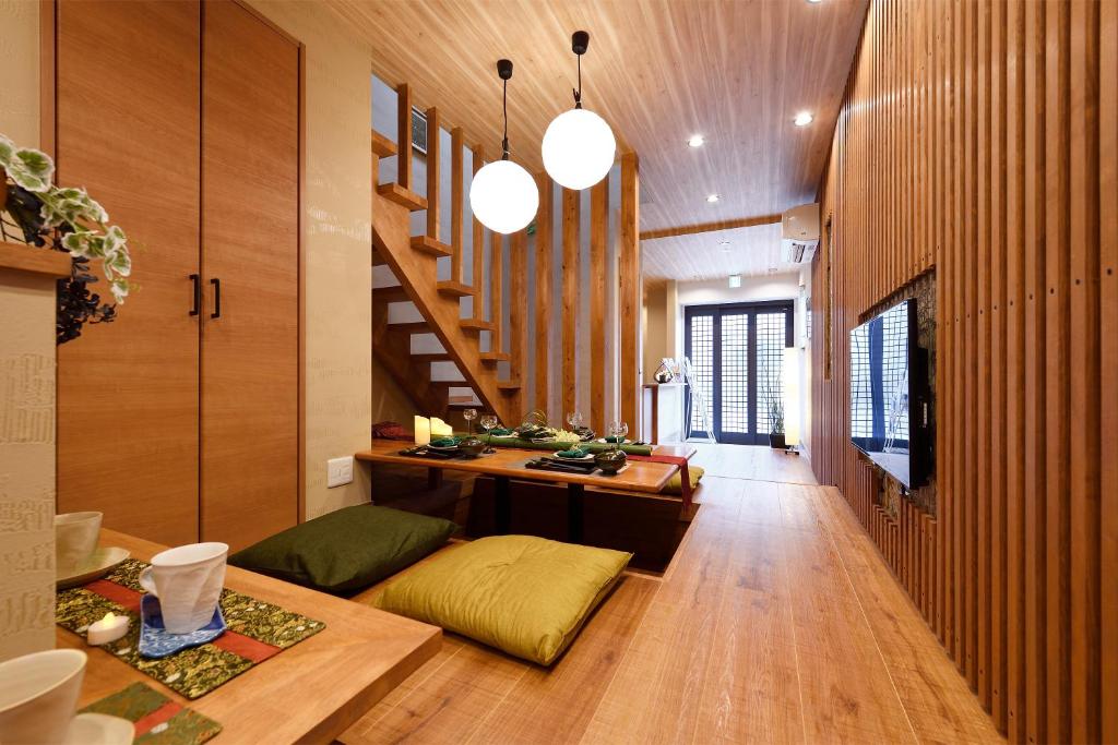a living room with wooden floors and a staircase at Ixyz杜 in Nagoya