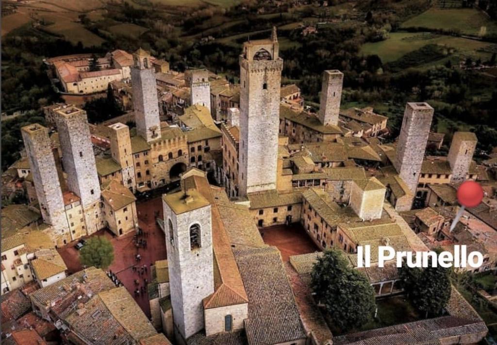 an aerial view of a building with a clock tower at IL PRUNELLO - una casa tra le Torri in San Gimignano
