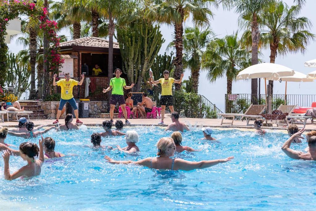 a group of people in a swimming pool at Hotel Olimpo le Terrazze in Letojanni