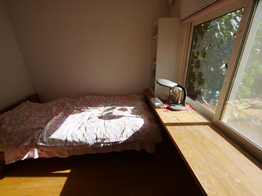 Postel nebo postele na pokoji v ubytování Minpaku Mon
