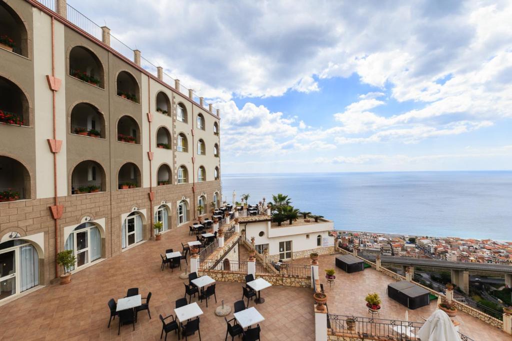 a view of the ocean from the balcony of a building at Hotel Olimpo le Terrazze in Letojanni