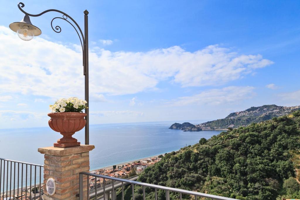 a street light and a view of the ocean at Hotel Olimpo le Terrazze in Letojanni