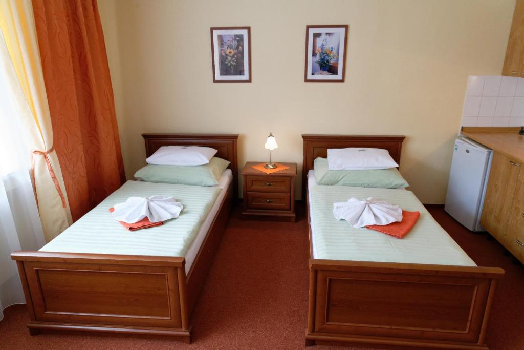 Postel nebo postele na pokoji v ubytování Hotel KAMU GARNI