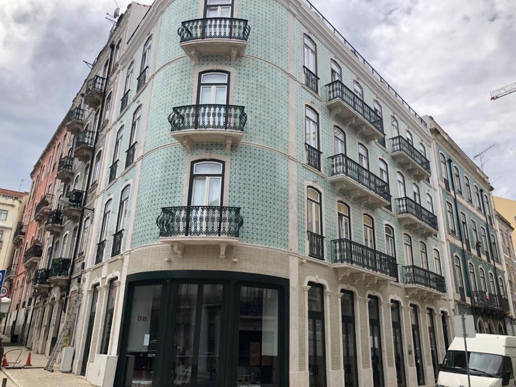 a blue building with balconies on the side of it at Be Lisbon Hostel Intendente in Lisbon