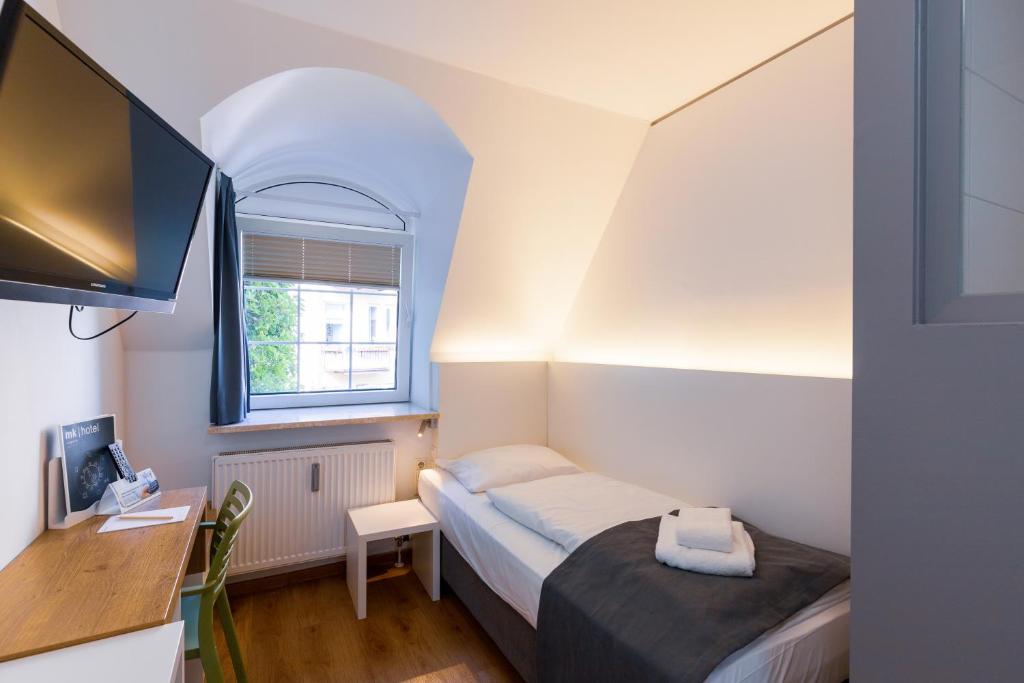 Postel nebo postele na pokoji v ubytování mk hotel münchen max-weber-platz