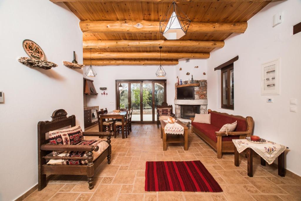 ArádhainaにあるARADENA TRADITIONAL House 4の木製の天井と赤い敷物が備わるリビングルーム