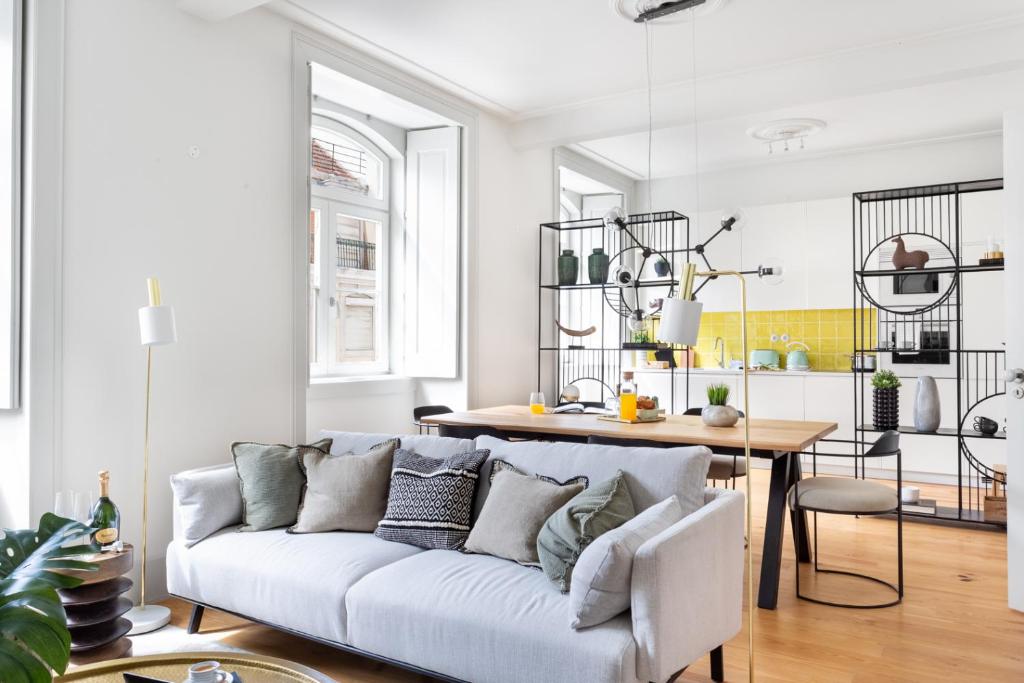 a living room with a couch and a table at ALTIDO Downtown Bliss Apartments in Lisbon