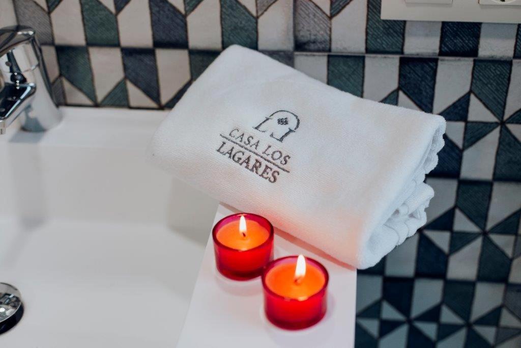 three candles sitting on a bathroom sink with a towel at CASA LOS LAGARES in Moriles