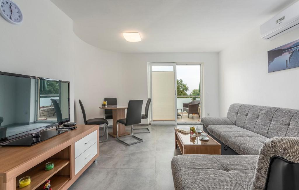 a living room with a couch and a flat screen tv at Apartments Smilys in Novigrad Istria
