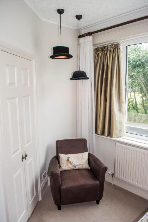 a chair sitting in a room with a window at Beachlands Hotel in Weston-super-Mare