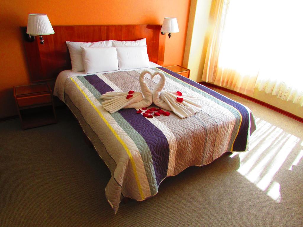 Postel nebo postele na pokoji v ubytování Maya Inn