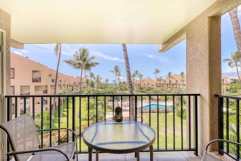 a patio with a table and chairs on a balcony at Kamaole Sands in Wailea