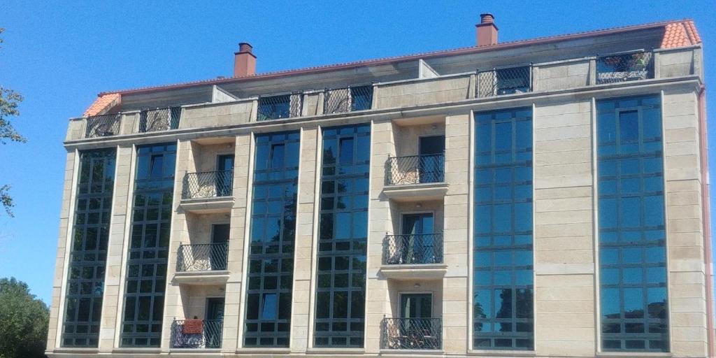 a large building with glass windows on the side of it at Iacobus VUT-CO-00371O in Padrón