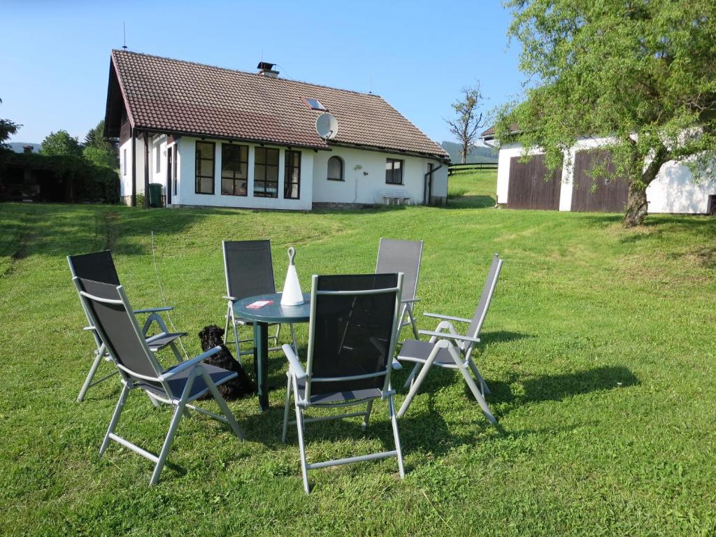 a group of chairs and a table in a yard at Holiday Villa Ruprechtice in Ruprechtice
