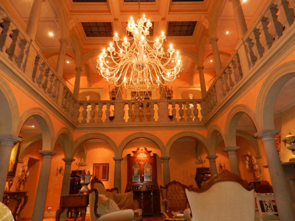 a large room with a chandelier in a building at Villa Bertagni in Castelnuovo di Garfagnana