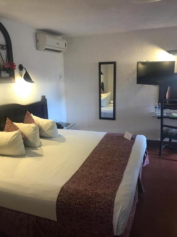 Postel nebo postele na pokoji v ubytování Hotel Maya Yucatan
