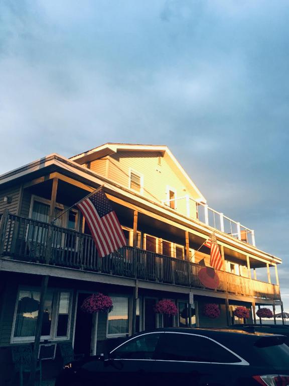 a building with two american flags on a balcony at The Skylark Beach Inn in Old Orchard Beach