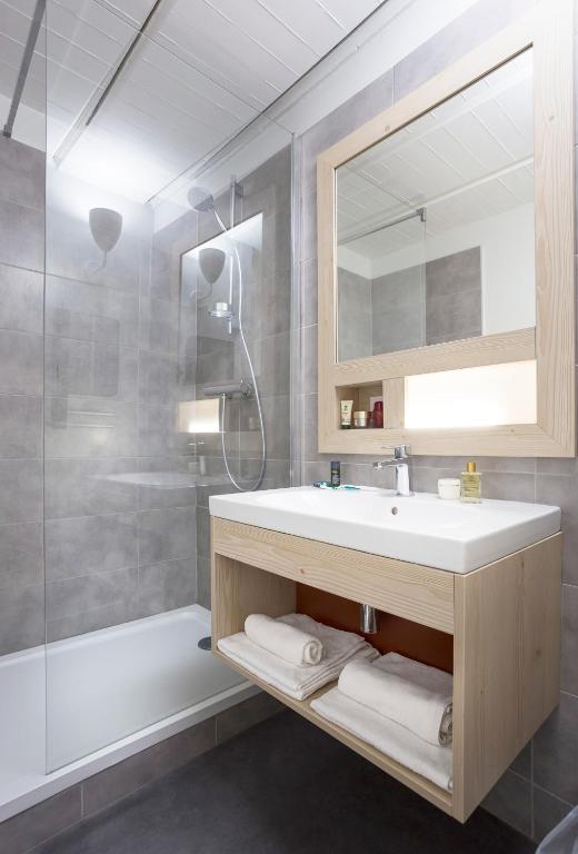 a bathroom with a sink and a shower at Hôtel Club mmv Le Flaine *** in Flaine