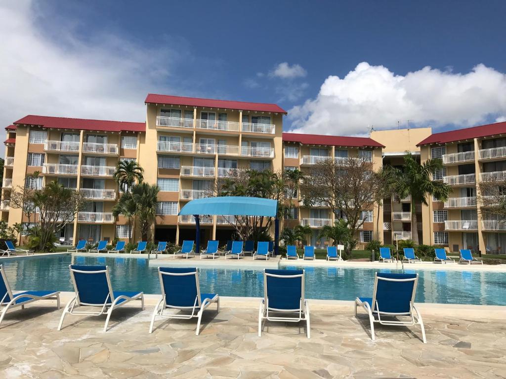 a resort with chairs and a swimming pool at Divi Southwinds Beach Resort in Christ Church