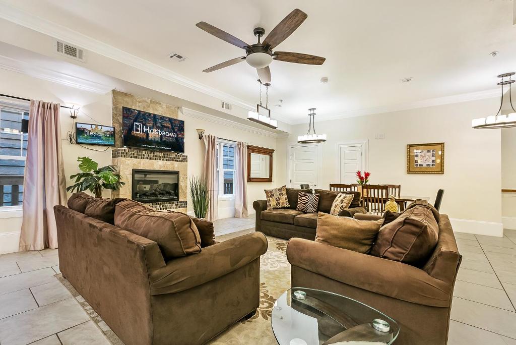 a living room with two couches and a fireplace at Modern 4BR City Condo 5min drive to FQ in New Orleans