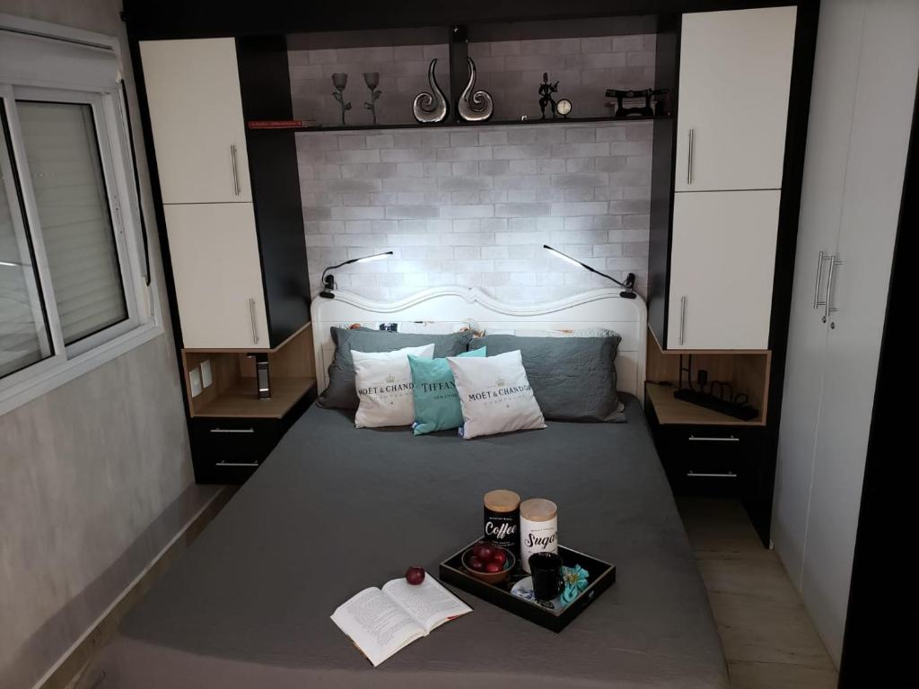 a bedroom with a bed with a tray of food on it at Flat de luxo São Paulo - Guarulhos in Guarulhos