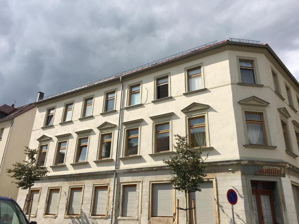 a large white building with windows on a street at Wohnen in 09599 Freiberg, Buchstraße 14 in Freiberg