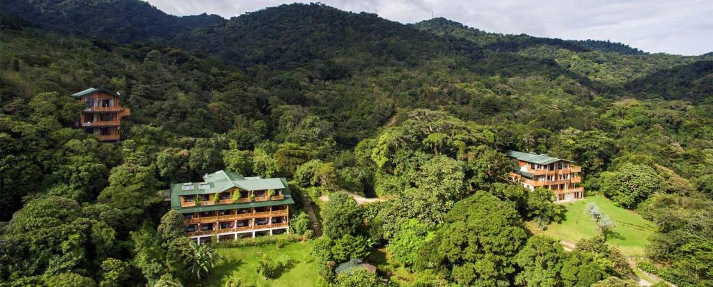 a house with trees and a mountain range at Hotel Belmar in Monteverde Costa Rica