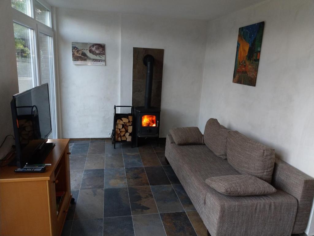 a living room with a couch and a fireplace at Ferienwohnung Thöne in Horstmar