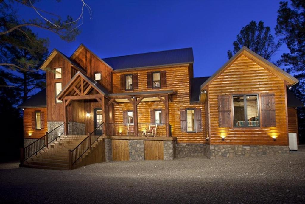 a large wooden house at night with lights at Call It A Day Luxury Cabin in Stephens Gap