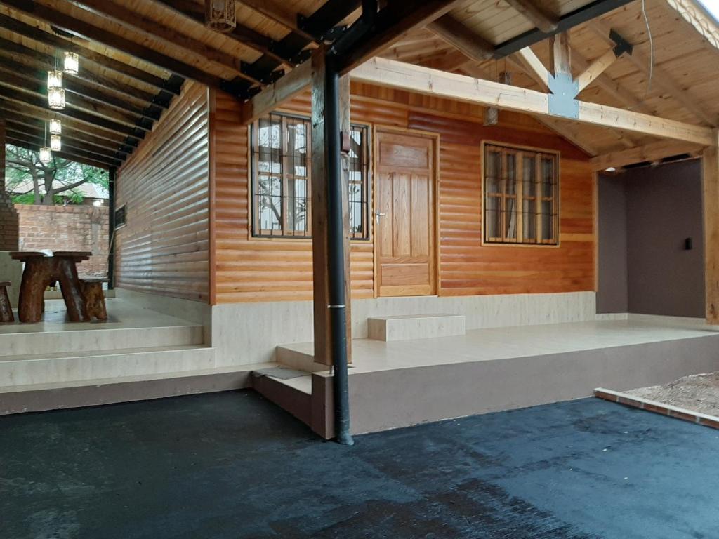 Elle offre une vue intérieure sur une maison en bois dotée d'une terrasse couverte. dans l'établissement Cabañas Jas, à Puerto Iguazú