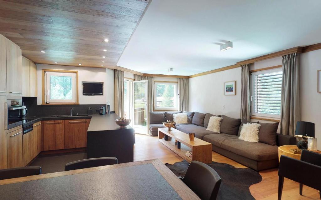 a living room with a couch and a table at Ruinatsch 67 in St. Moritz
