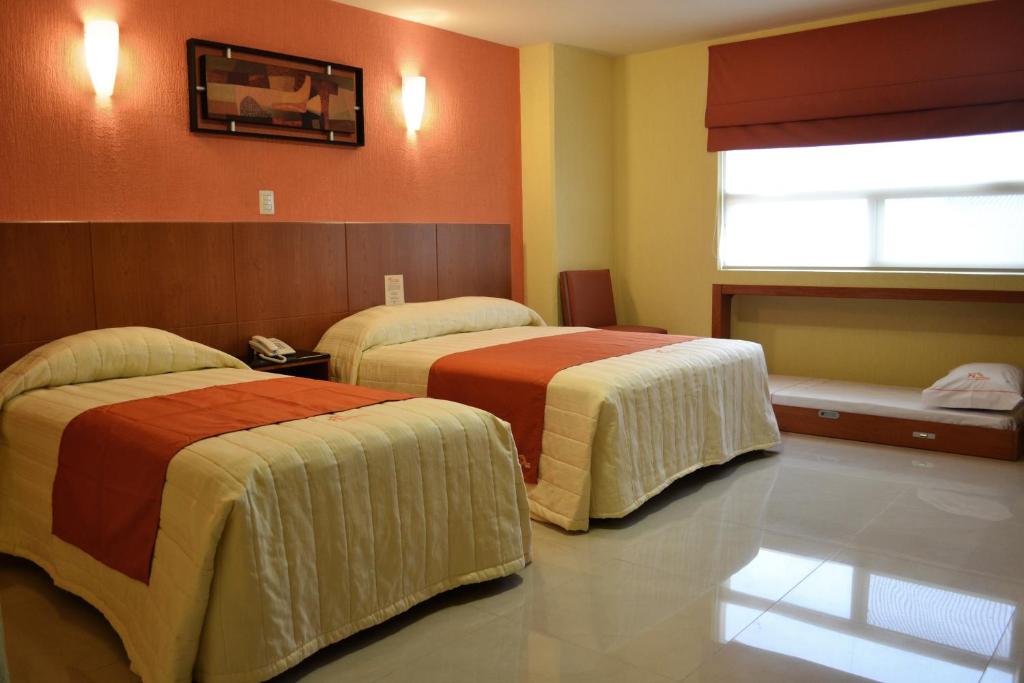 Postel nebo postele na pokoji v ubytování Hostalia Hotel Expo & Business Class