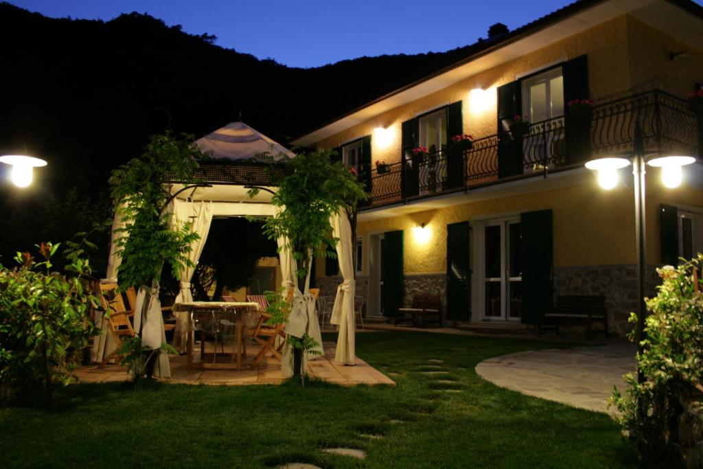 a house with a table in the yard at night at Cà de Pria in Casarza Ligure
