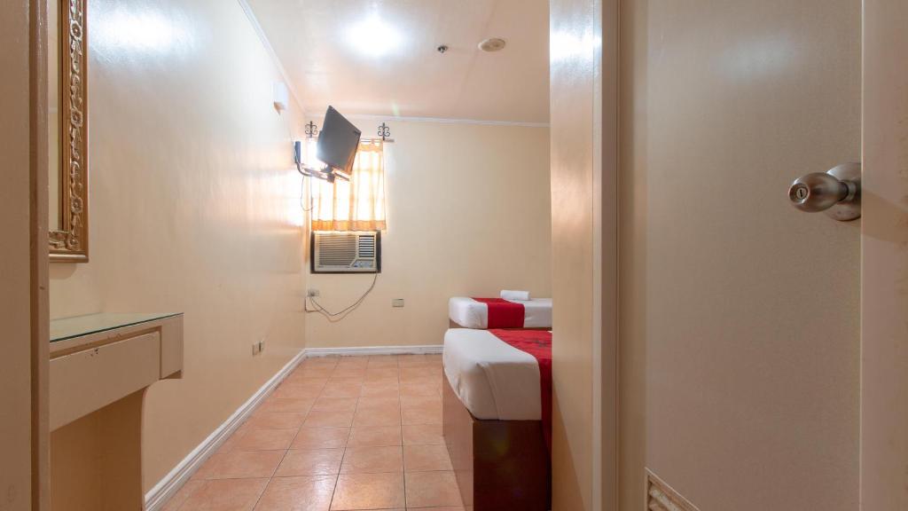 Postel nebo postele na pokoji v ubytování RedDoorz @ Downtown Tacloban