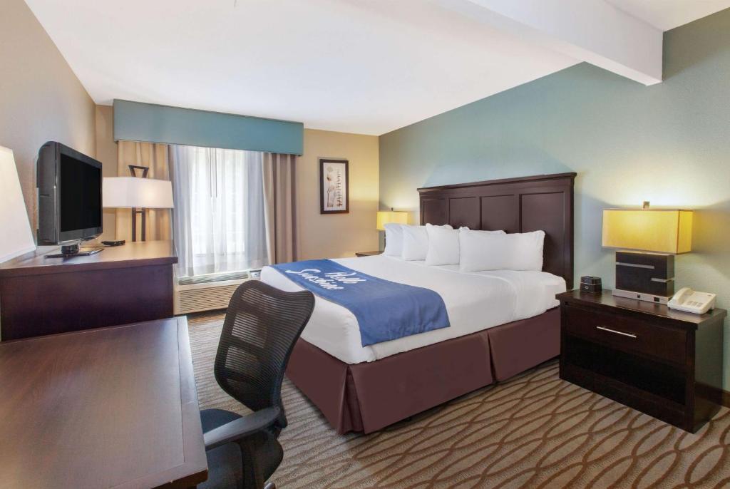 a hotel room with a bed and a television at Days Inn by Wyndham Petoskey in Petoskey