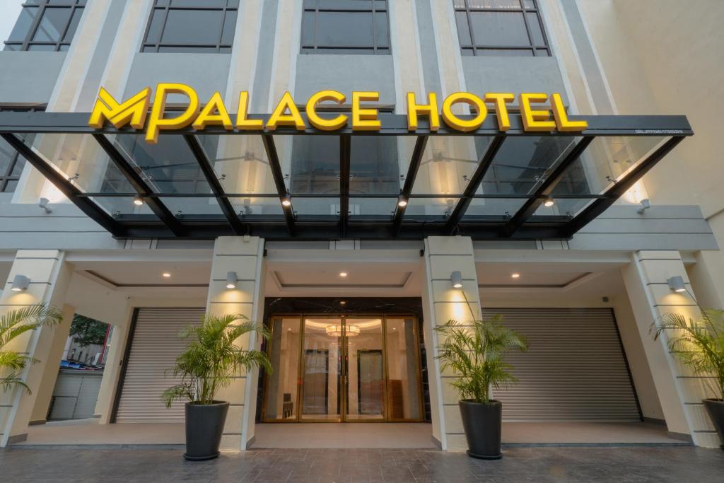 a large hotel with a large sign on top of it at MPalace Hotel KL in Kuala Lumpur