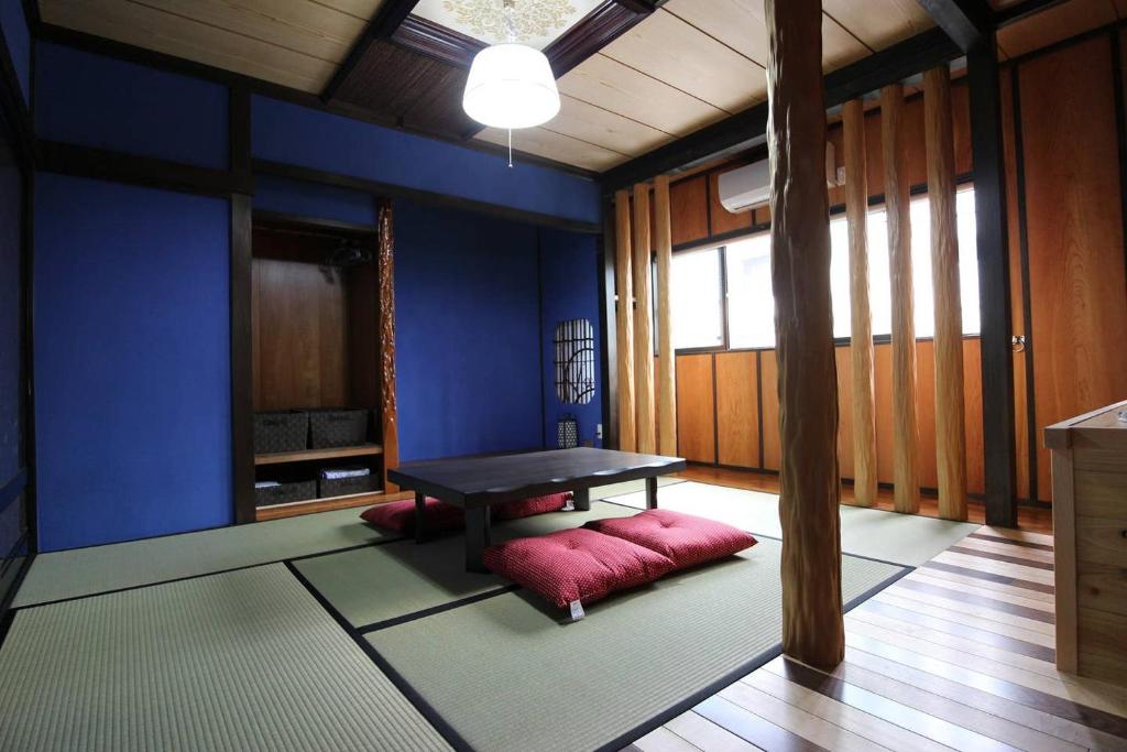 a room with a table and a bench in it at 小さなお宿 乃むら in Kanazawa