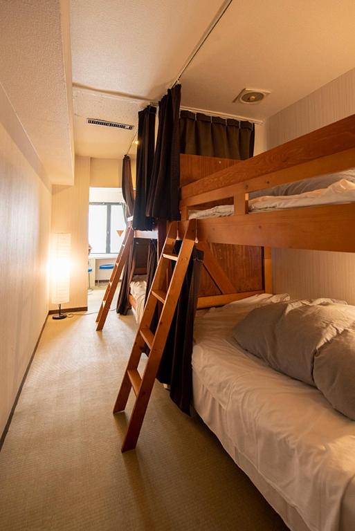 Postel nebo postele na pokoji v ubytování Guest House M104 Kagoshima