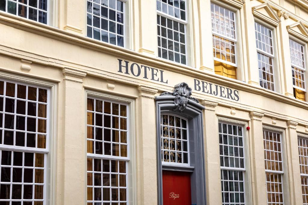 a hotel building with a red door and many windows at Hotel Beijers in Utrecht
