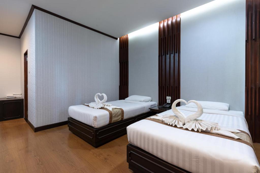 Postel nebo postele na pokoji v ubytování Pimann Inn Hotel