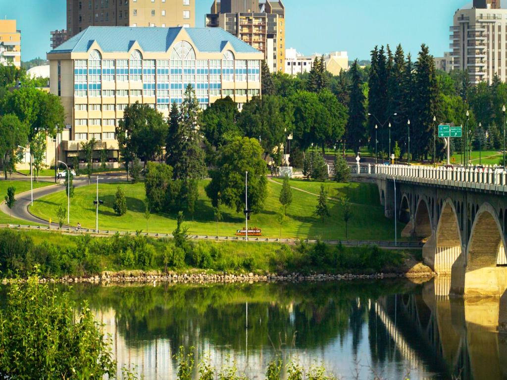 a bridge over a river next to a city at Park Town Hotel in Saskatoon