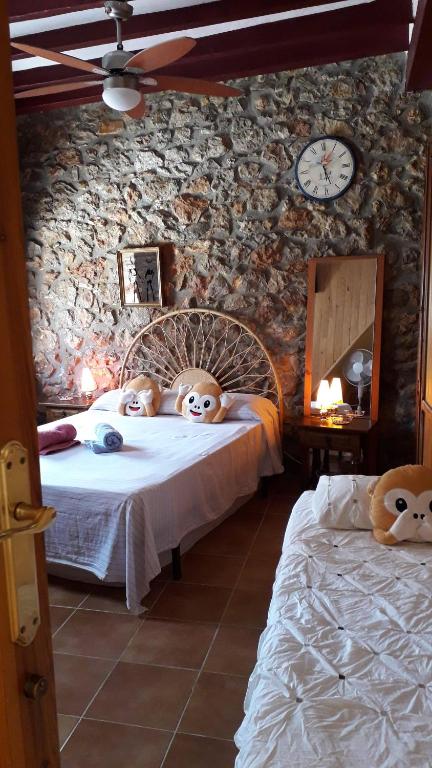 a bedroom with two beds with masks on them at Chez Berna - Se Alquila Habitacion in Denia