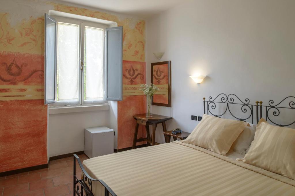 Postel nebo postele na pokoji v ubytování Hotel Porta Marmorea