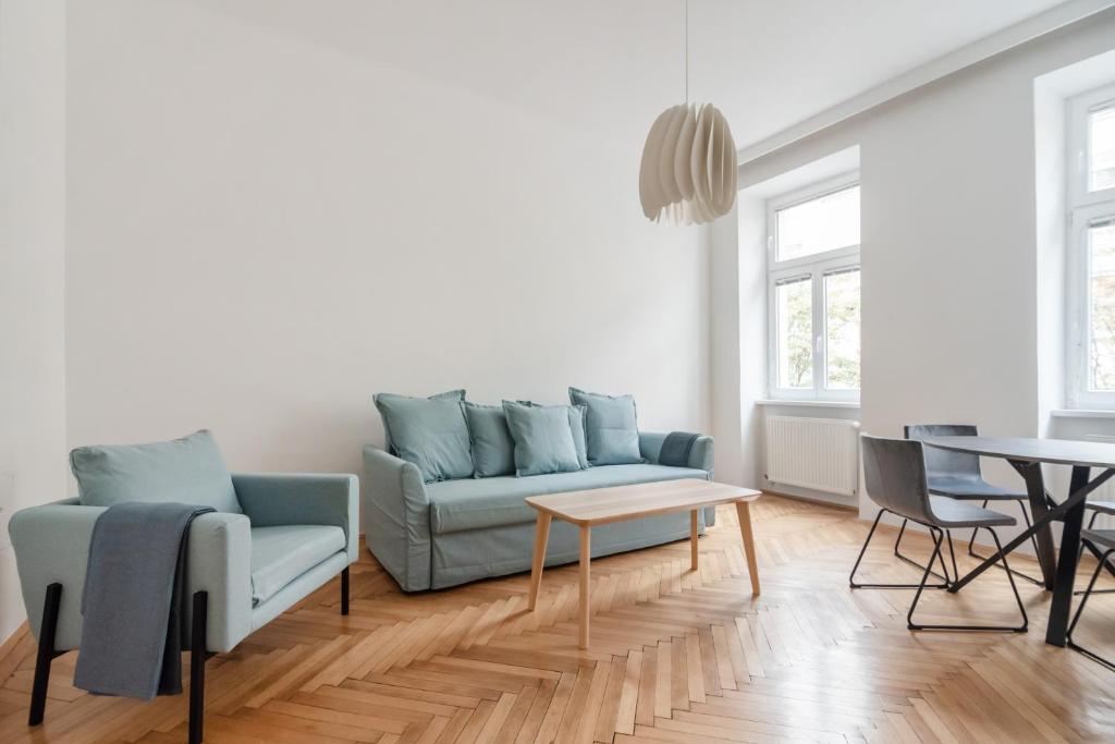a living room with a couch and a table at UNIVERSUM APARTMENT 2 in Vienna